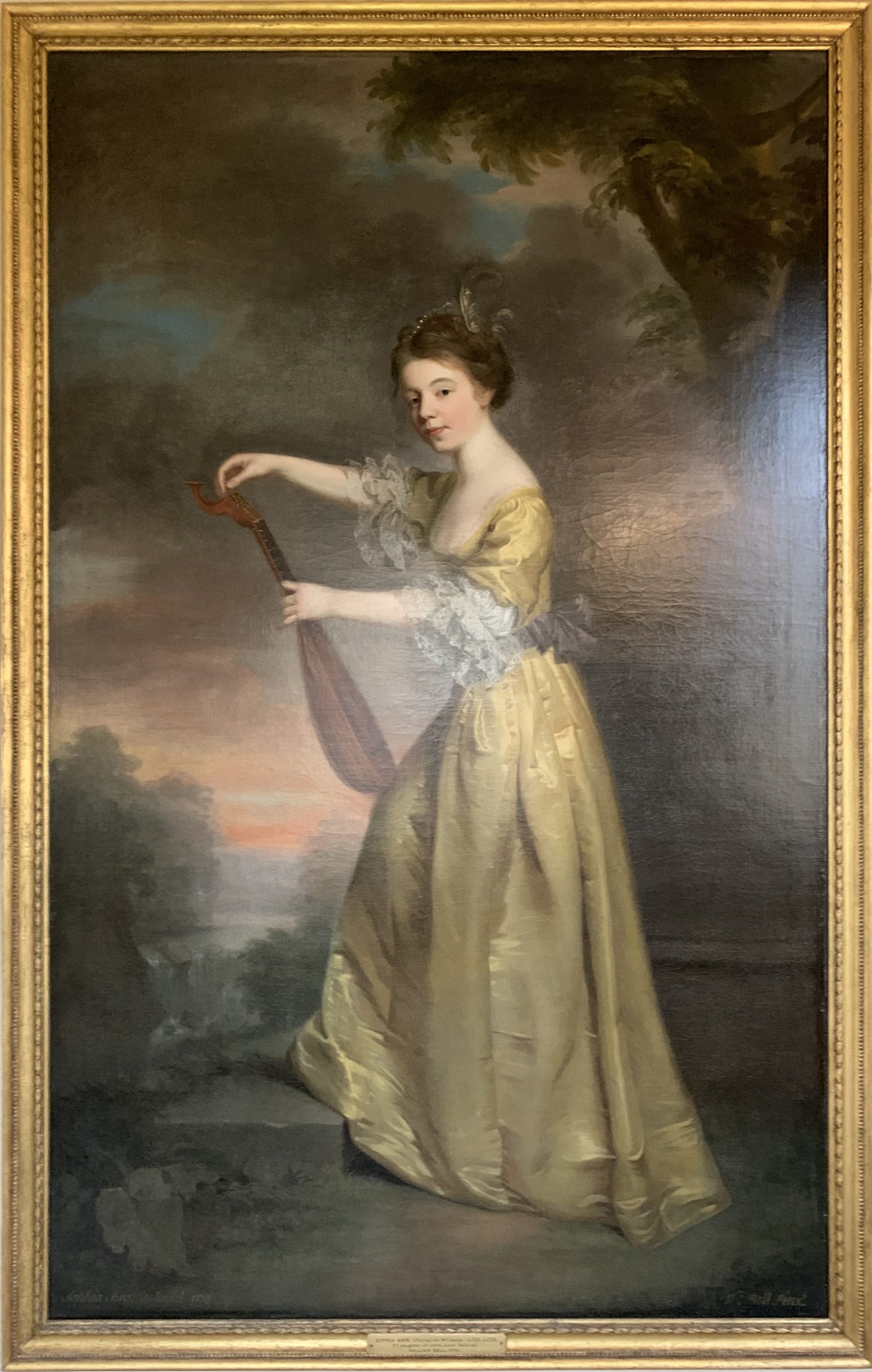 Sophia Anne Delaval, later Mrs John Jadis, as a girl, tuning a Mandolin in a Landscape Setting